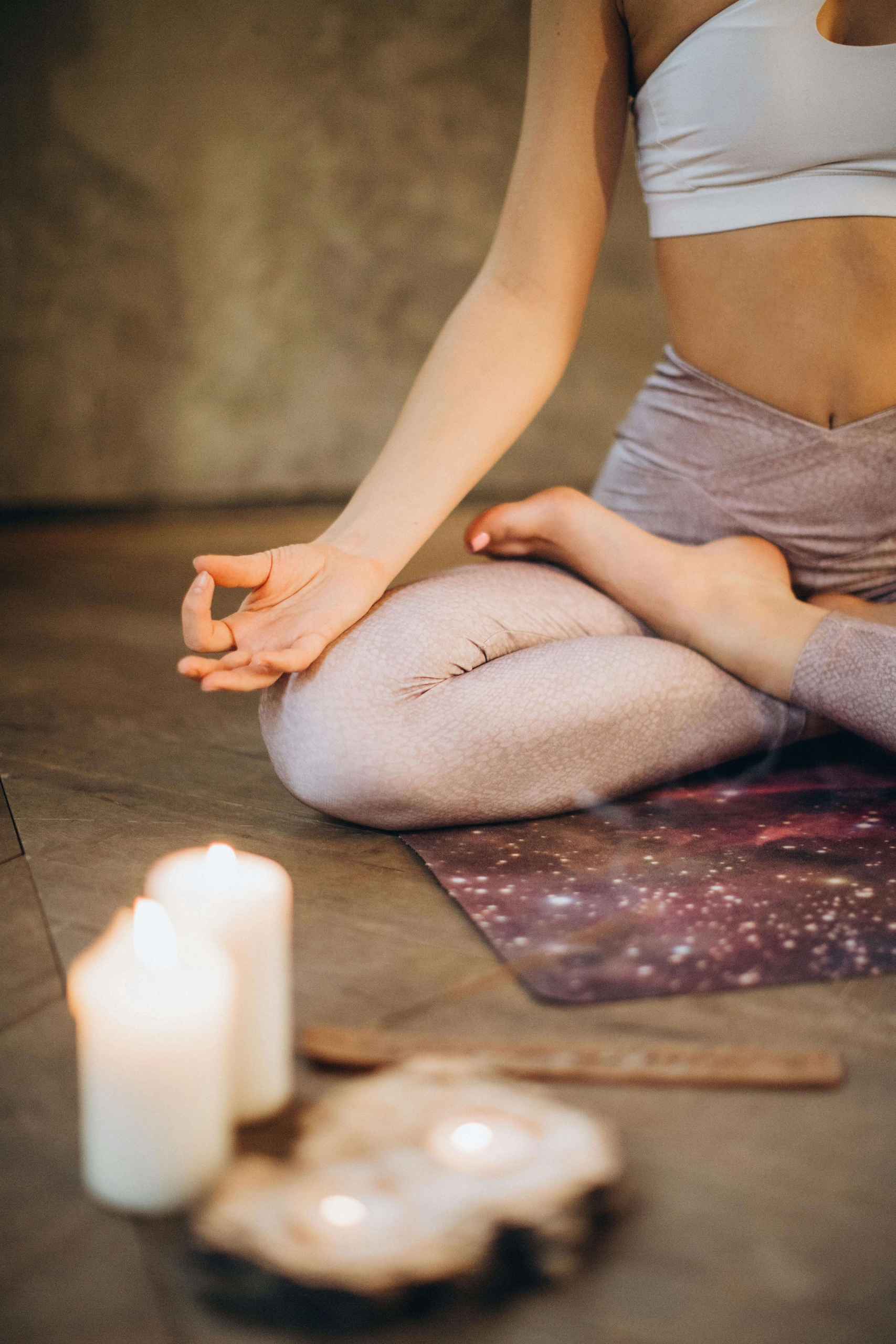 A woman meditates in a candle-lit space, reflecting the inner balance supported by SEO for functional medicine. Are you asking whether an SEO consulting firm can help your clinic reach those seeking holistic care? Clear, optimized content connects clients with integrative healing.