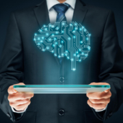 Business professional in a suit holding a tablet with a glowing digital brain above it, symbolizing technical SEO services that power private practice SEO, SEO for online therapy services, and search engine optimization for counselors.