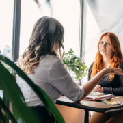 Holistic practitioner talking with a client in a bright office, representing how local seo for therapists and seo for mental health can help caring professionals fill their caseloads. This scene also reflects private practice seo and local seo for medical professionals supporting real conversations and healing.