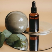 A small dropper bottle and natural elements rest on a mirrored surface, symbolizing simplicity and professionalism in holistic care. The image reflects how SEO helps build trust by presenting services clearly and authentically online. This supports long-term visibility through SEO for homeopathy professionals.