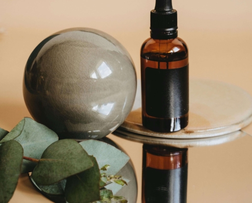 A small dropper bottle and natural elements rest on a mirrored surface, symbolizing simplicity and professionalism in holistic care. The image reflects how SEO helps build trust by presenting services clearly and authentically online. This supports long-term visibility through SEO for homeopathy professionals.