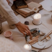 A person arranging crystals, candles, and spiritual tools on a mat during a calming, holistic ritual. Find your aligned clients and grow your SEO rankings with the support of Simplified SEO Consulting.