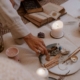 A person arranging crystals, candles, and spiritual tools on a mat during a calming, holistic ritual. Find your aligned clients and grow your SEO rankings with the support of Simplified SEO Consulting.