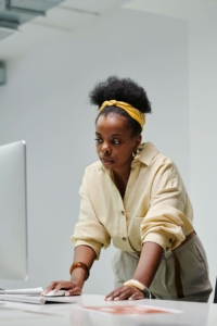 A focused professional woman working at a desk with a computer, symbolizing the dedication and expertise involved in integrative medicine SEO and SEO consulting services, featured in the blog 'Local SEO for Integrative Medicine: How to Dominate Your City’s Search Results'.