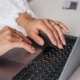 Close up of hands typing on a laptop keyboard while wearing gold rings. With integrative medicine SEO, intentional content creation becomes a powerful way to turn online searches into real patient inquiries.