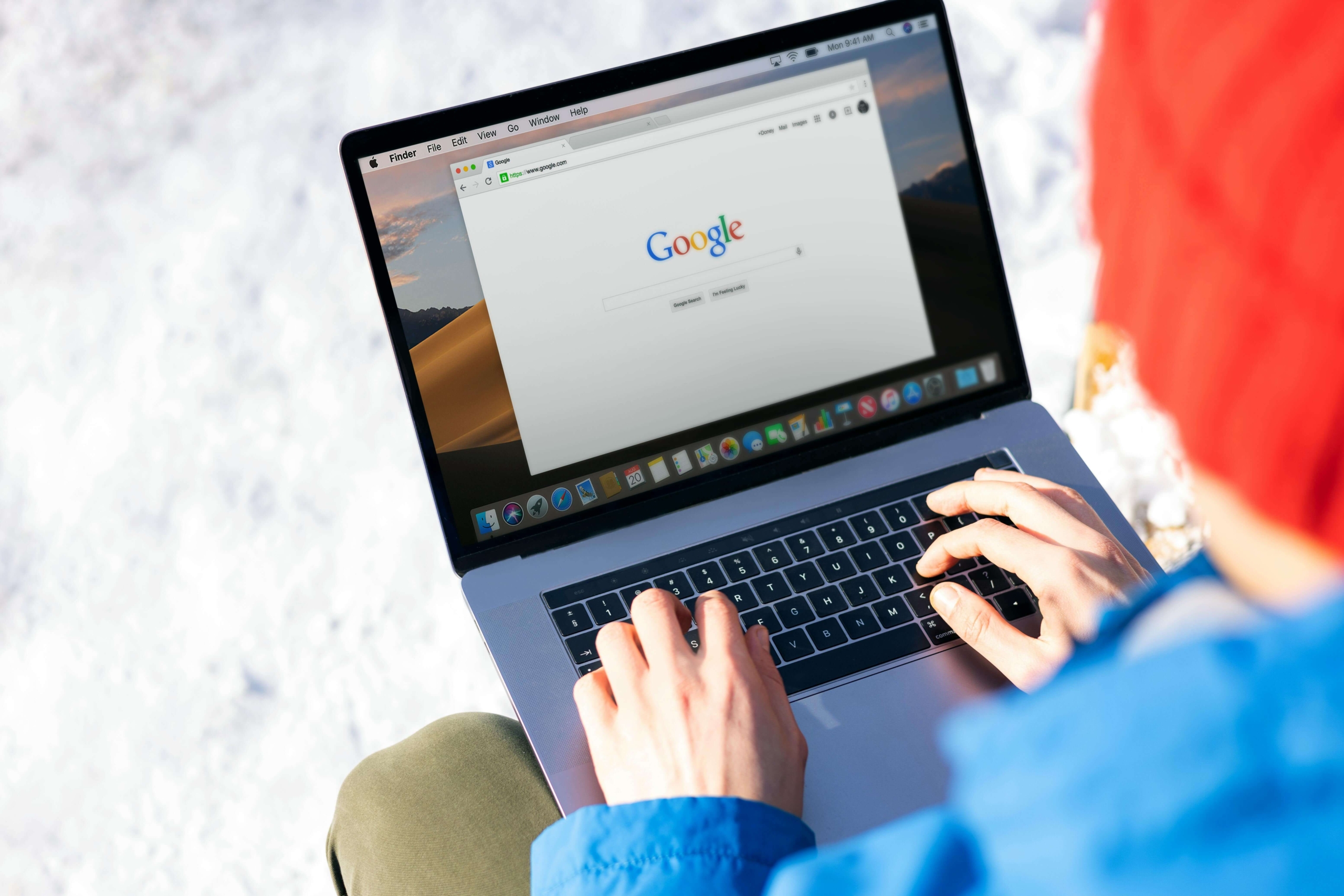 Person searching Google on a laptop, illustrating how alternative healing SEO helps holistic practitioners get discovered online.