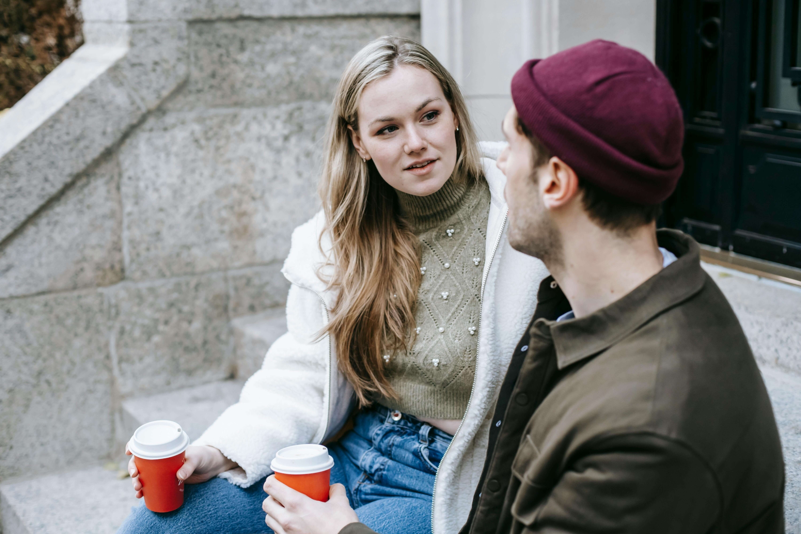 Two people having a relaxed conversation outdoors, symbolizing word-of-mouth growth paired with effective alternative healing SEO strategies.