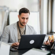 Alternative healer researching alternative healing SEO strategies on laptop while considering hiring a local SEO consultant to grow their wellness practice