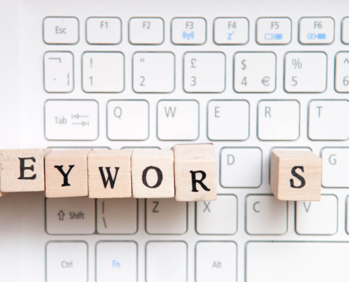 Wooden letter blocks spelling “keywords” on a computer keyboard, representing keywords for therapists and seo keywords for therapists when writing website copy. A helpful reminder that seo keywords for mental health can be woven in naturally across key pages.