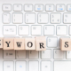 Wooden letter blocks spelling “keywords” on a computer keyboard, representing keywords for therapists and seo keywords for therapists when writing website copy. A helpful reminder that seo keywords for mental health can be woven in naturally across key pages.