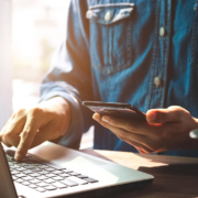A person using a laptop and smartphone to search online, representing how SEO for therapists and private practice SEO work together to connect therapists with clients across multiple devices