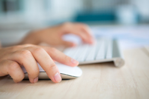 A person navigates Google Search Console using a mouse and keyboard to check for indexing errors on their website. Knowing how to find and read these errors is an important step in SEO for therapists who want to protect their online visibility. 