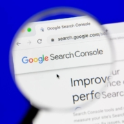 A magnifying glass zooms in on the Google Search Console homepage on a computer screen. Understanding tools like GSC is a key part of technical SEO services for therapists and helping professionals.