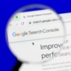 A magnifying glass zooms in on the Google Search Console homepage on a computer screen. Understanding tools like GSC is a key part of technical SEO services for therapists and helping professionals.