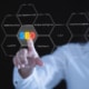 A person in a white shirt points at a digital display of hexagonal shapes showing SEO related terms including local SEO, artificial intelligence, EEAT, voice search, and mobile friendliness against a dark background. Understanding the full picture of SEO for therapy practice means knowing which fundamentals actually move the needle for your practice.