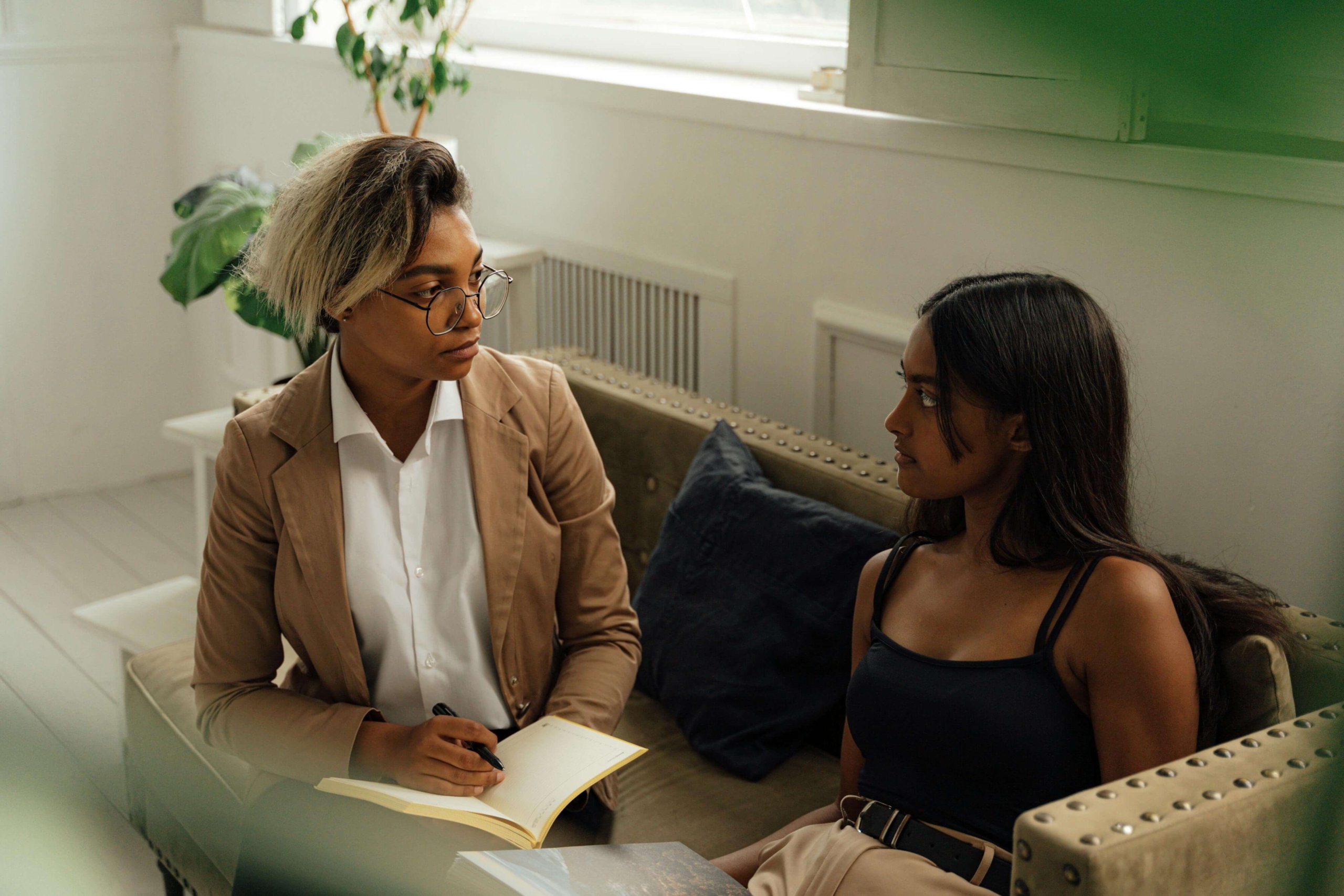 Therapist meeting with a client in session, representing professional growth and visibility supported through SEO help for therapists.