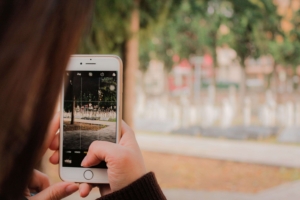A person taking a photo with their iphone. A social media manager can support your online presence by reaching ideal clients on Instagram or Facebook. Learn more about social media marketing here.