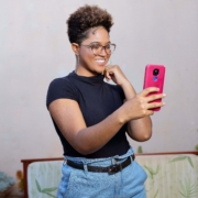 A Black woman standing, taking a selfie with her phone. If your social media isn't reaching the right people, it may be time for a social media manager. Learn how Simplified SEO can help.