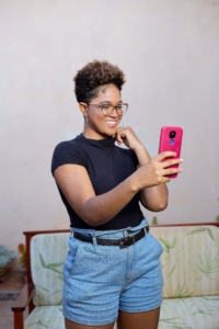 A Black woman standing, taking a selfie with her phone. If your social media isn't reaching the right people, it may be time for a social media manager. Learn how Simplified SEO can help.