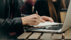 A person writes notes by hand in a notebook while working on a laptop. Taking a thoughtful, human-led approach to content creation is essential for SEO for mental health professionals — AI can offer a starting point, but real strategy requires intentional review, refinement, and a voice that is authentically your own. 