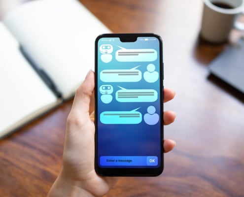 A hand holds a smartphone displaying a chatbot conversation. What makes content more likely to be picked up by AI-driven search tools? Therapist SEO strategies now account for how AI models source and reference information.