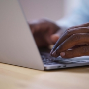 Close-up of someone typing on a laptop, representing content creation and the role SEO plays in helping information get discovered through how search engines work.