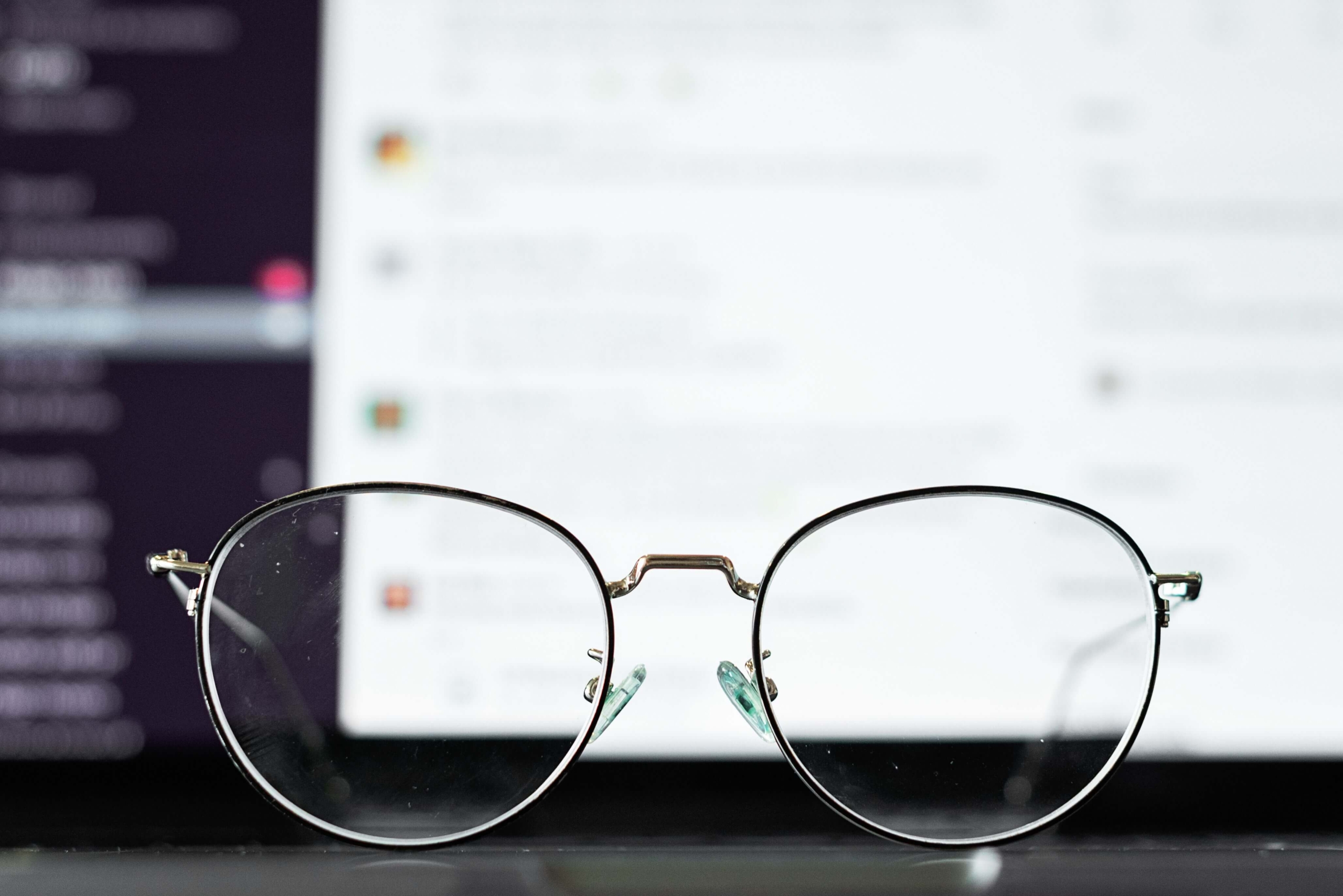 AI and SEO - seo strategy - ai search optimization - search engine optimization Close-up of glasses with a digital screen in the background, representing the relationship between AI and SEO in modern search.