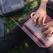 Person sitting outside and creating content on a laptop, representing thoughtful content development that builds content authority.