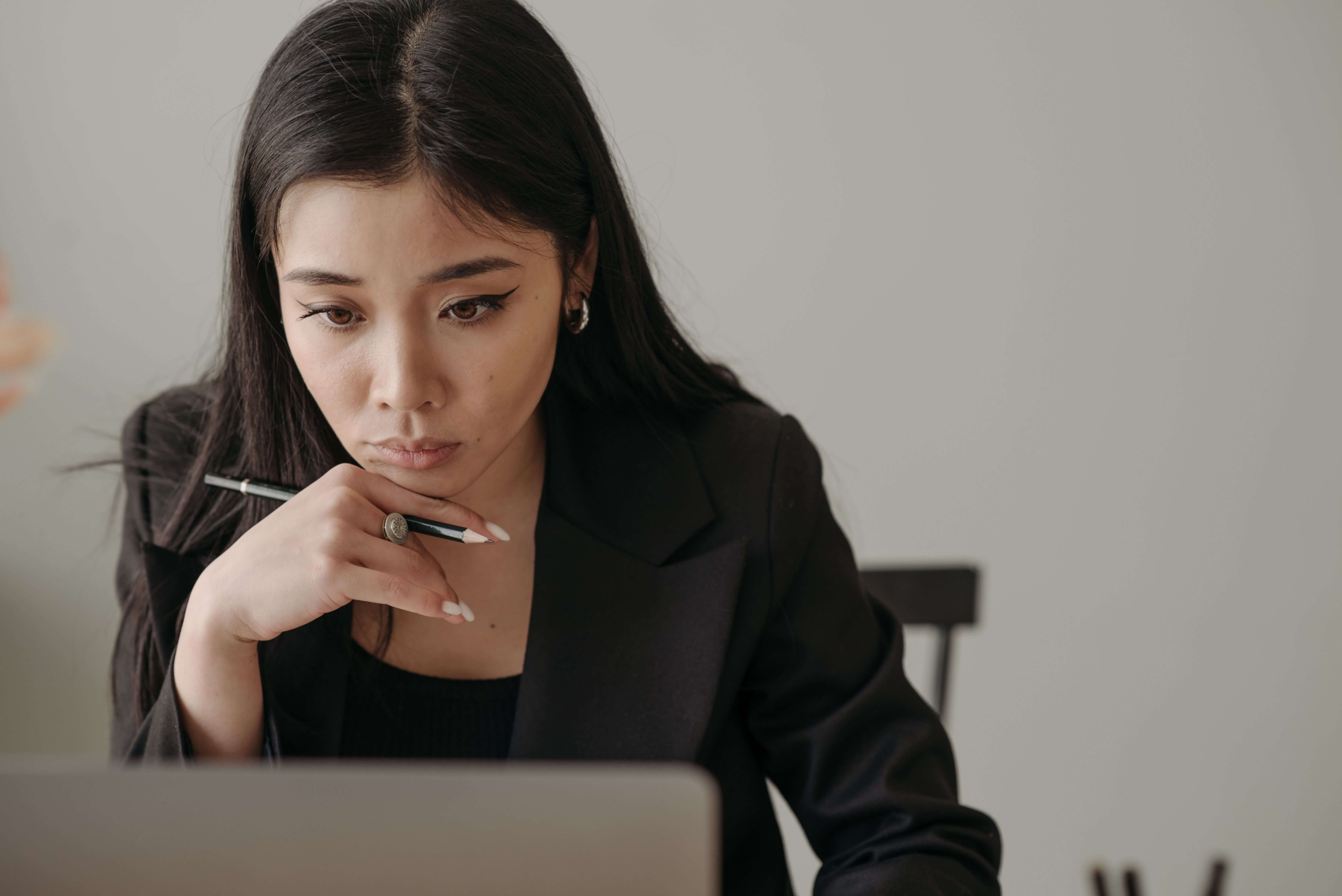 Person looking intently at a computer, reflecting the research and strategy involved in creating content that demonstrates content authority.